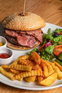 Delicious beef burger with bacon and french fries. isolated image