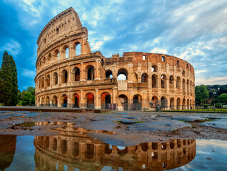 Colosseum morning in Rome, Italy. Colosseum is one of the main attractions of Rome. Coliseum is reflected in puddle. Rome architecture and landmark.