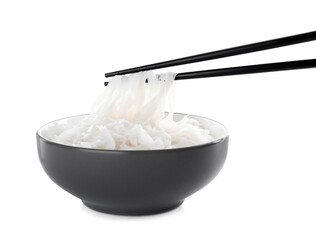 Chopsticks with cooked rice noodles over bowl isolated on white
