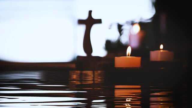 Candlelight, holy water, the cross of the holy Christ, and a relaxing time of contemplation
