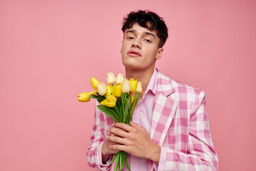 cute guy in a plaid jacket with a bouquet of flowers gift date