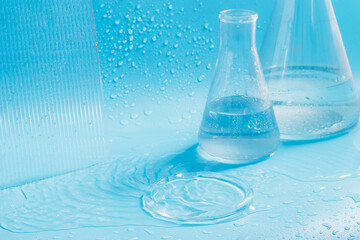 Empty podium with glass labware, flask bowl platform. Research and development of cosmetics in the laboratory.