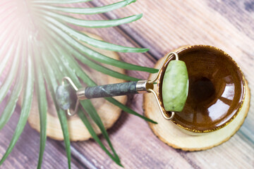 Jade roller facial massager and palm branch