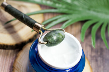 Jade massager and face cream, spa salon