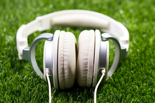 Big White Headphones On The Grass In The Garden