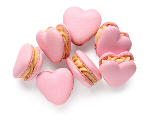 Tasty heart-shaped macaroons on white background
