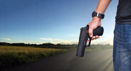 9mm automatic pistol holding in right hand of gun shooter, concept for security, robbery, gangster, bodyguard around the world. selective focus on pistol.