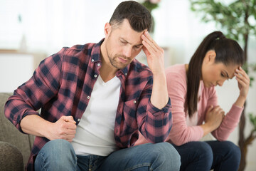 couple fight and sit on the sofa