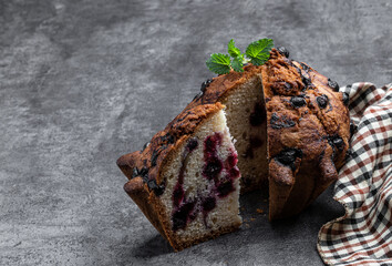 Homemade big berry muffin on concrete background