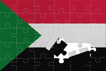 World countries. Broken puzzle- background in colors of national flag. Sudan