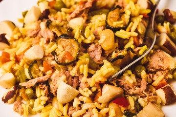 Paella plate with tuna and Brazil nuts.