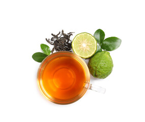 Glass cup of tasty bergamot tea, dry leaves and fresh fruits on white background, top view