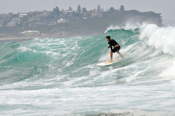 A surfer in action at Fairy Bower in Sydney, Australia