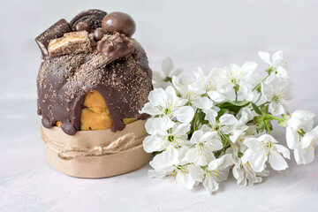 Easter still life. Traditional pastries, painted eggs and white cherry flowers on a light delicate background.