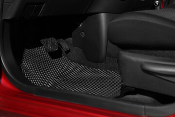 Fototapeta na wymiar Black rubber car floor mat in auto