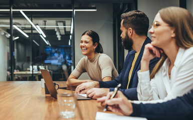 Happy businesswoman laughing while leading a meeting