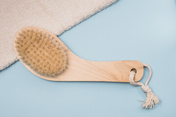 Massage brush on blu background.Spa and natural skin care concept
