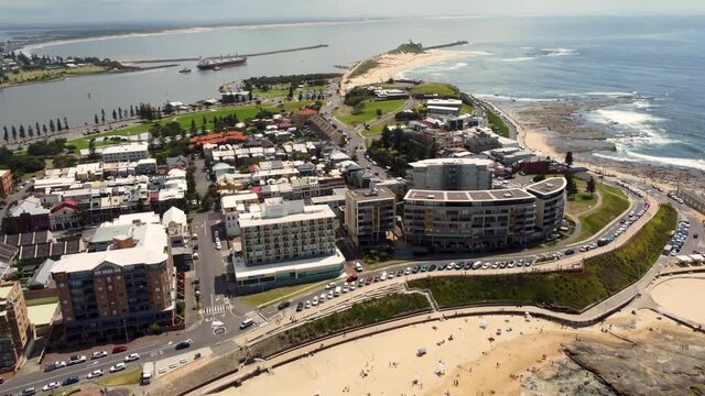 Aerial drone view of Newcastle Beach foreshore Nobbys Beach Newcastle Harbour City CBD tourism NSW Australia 4K
