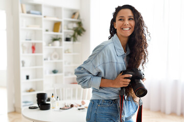 Cheerful Arabic Photographer Woman Holding Photo Camera Indoors