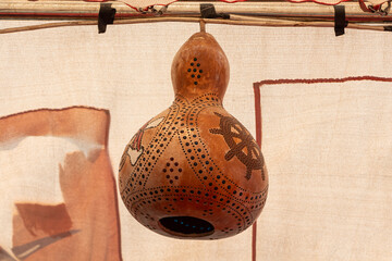 Beautiful orange decorative pumpkin lamp on the beige background is outside