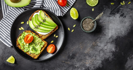 Healthy avocado toasts for breakfast or lunch with rye bread, cream cheese, arugula, sliced...