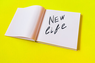 New life. Notepad with blank pages on a yellow background.High quality photo