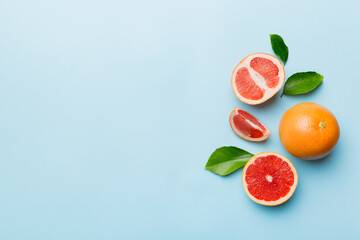 fresh Fruit grapefruit with Juicy grapefruit slices on colored background. Top view. Copy Space. creative summer concept. Half of citrus in minimal flat lay with copy space