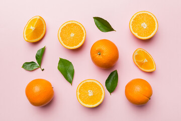 Fruit pattern of fresh orange slices on colored background. Top view. Copy Space. creative summer concept. Half of citrus in minimal flat lay