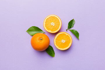 Fruit pattern of fresh orange slices on colored background. Top view. Copy Space. creative summer concept. Half of citrus in minimal flat lay