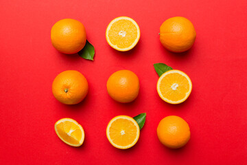 Fruit pattern of fresh orange slices on colored background. Top view. Copy Space. creative summer concept. Half of citrus in minimal flat lay