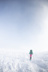 Fototapeta na wymiar A hiker walks in snowshoes in the snow