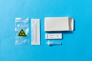 medicine, self testing and pandemic concept - coronavirus nasal test kit on blue background