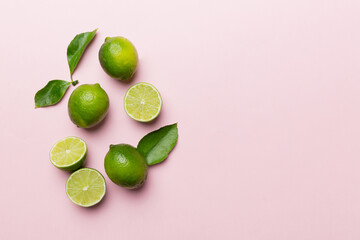Lime fruits with green leaf and cut in half slice isolated on white background. Top view. Flat lay with copy space