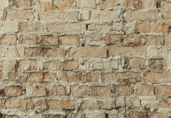 Horizontal brick tile background, abstract texture. Old and weathered brick wall close up. Grunge house facade.