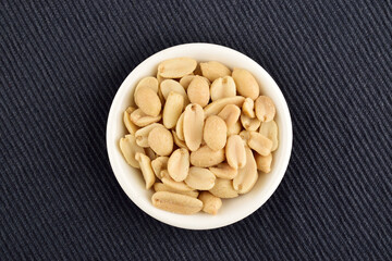 Top View of Salted Peanut in Bowl over Blue Placemat