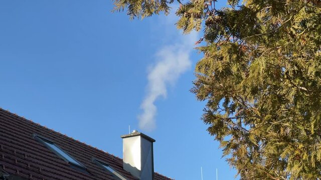 smoke fumes from chimney in winter