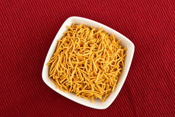 Aloo Bhujia Namkeen in Bowl on Red texture Cloth
