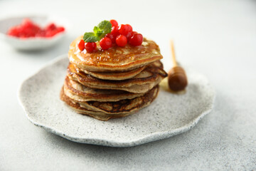 Homemade pancakes with berries and honey
