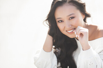 Beautiful woman outdoors. Pretty lady on urban background. Asian female closeup portrait.