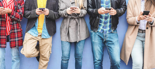 Young people using mobile phones outdoor - Focus on faces