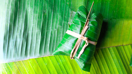 Bundle of bananas with Sticky Rice on banana leaves