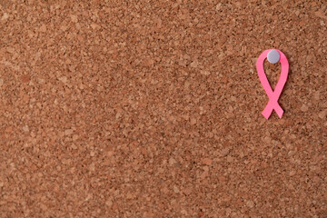 Pink ribbon put on cork board, horizontal copy space