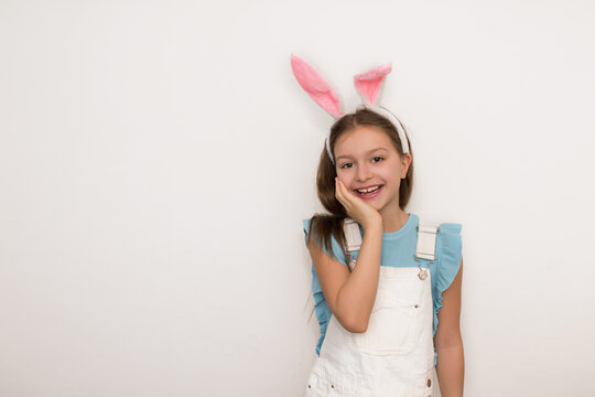 Portrait of smiling brunette girl in bunny ears looking at camera, Happy easter