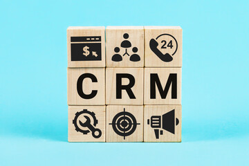 Concept CRM or Customer Relationship Management. Customer Relationship concept. Word CRM on wooden cubes. Bones form words CRM.
