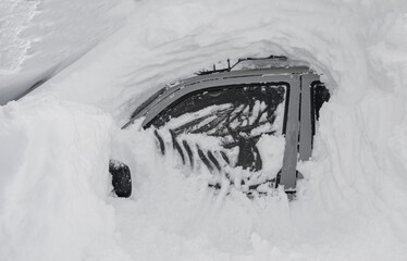 car covered with snow after a heavy snow storm.