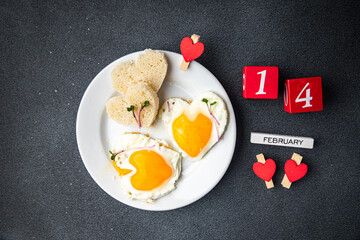 valentines day egg fried breakfast on the table scrambled eggs heart shape holiday decoration love date copy space food background