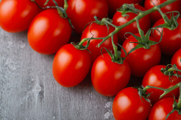 Bunch of fresh, red tomatoes with green stems