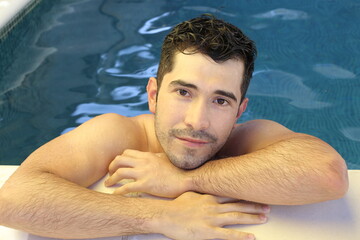 Natural looking young man in swimming pool