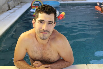 Natural looking young man in swimming pool
