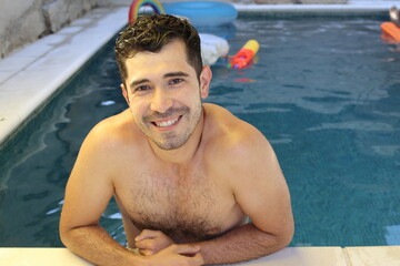 Natural looking young man in swimming pool
